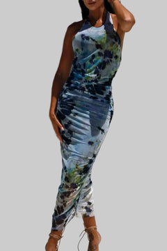 Backless printed halter neck dress in multicolor pattern.