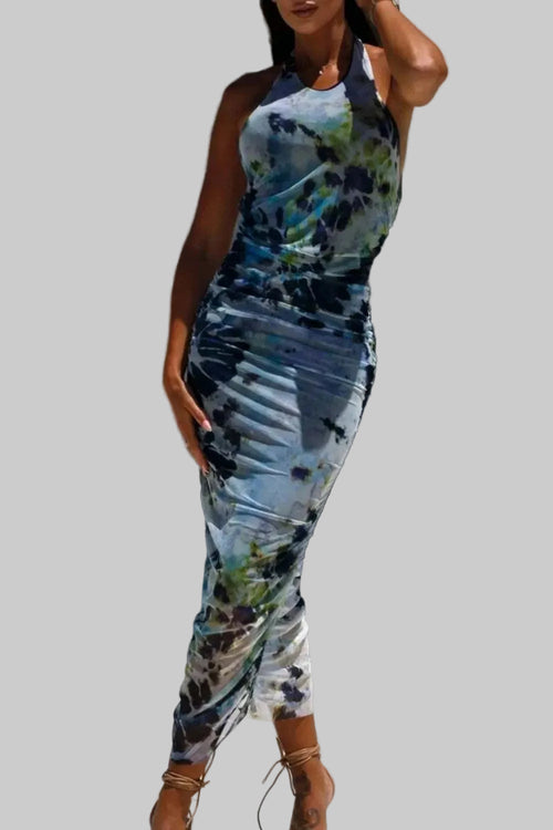 Backless printed halter neck dress in multicolor pattern.