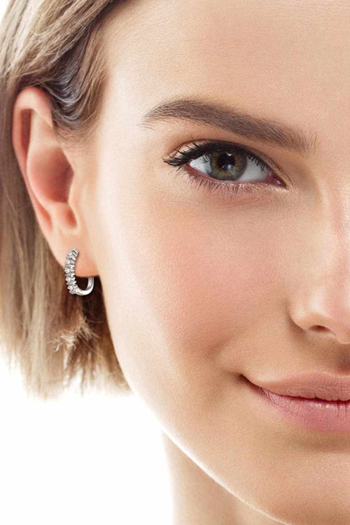 Moissanite 925 sterling silver minimalist earrings on a model.