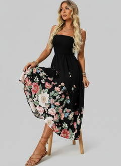 Floral printed tube midi dress with black top and colorful skirt, beach setting in background.