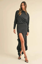 Woman wearing black Mable Backless Asymmetric Ruffle Hem Dress with high slit and ruffle detail