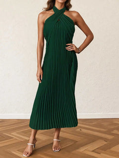 Dark green pleated halter neck midi dress with crossed neckline and sleeveless design.