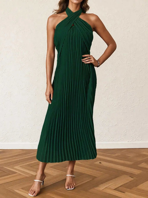 Dark green pleated halter neck midi dress with crossed neckline and sleeveless design.