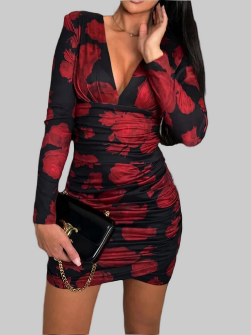 Ruched plunge long sleeve wrap dress with red floral pattern.