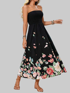 Printed tube midi dress with floral design, sleeveless, black polyester fabric, beach background.
