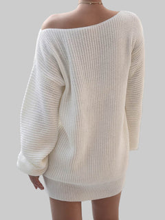 Back view of woman wearing white rib-knit mini sweater dress with off-shoulder design in a bright room