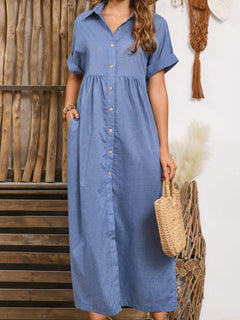 Blue buttoned midi dress with slit and collared neck, featuring pockets and short cuffed sleeves