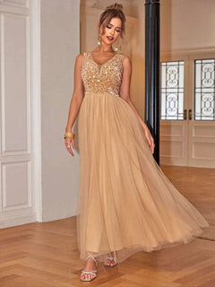 Sequin V-Neck Sleeveless Dress in gold with flowing skirt, styled on model.