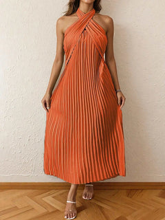 Orange pleated halter neck midi dress with a tied neckline and no stretch, made of 100% polyester.
