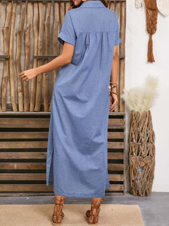 Back view of a blue collared midi dress with short sleeves and side slit, styled with brown sandals in a boho-inspired setting