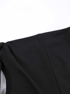 Close-up of black asymmetrical tied sleeveless maxi dress detail