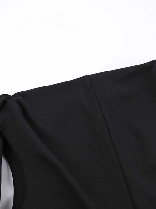 Close-up of black asymmetrical tied sleeveless maxi dress detail