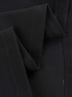 Close-up of black fabric detailing on asymmetrical tied sleeveless maxi dress made of 100% polyester