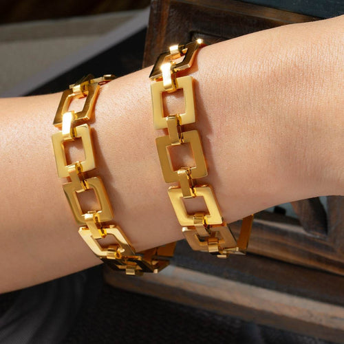 Gold-plated titanium steel chain bracelet with hollow square links worn on wrist for elegant style