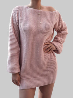 Woman wearing a pink rib-knit mini sweater dress with long sleeves and a slightly off-shoulder neckline