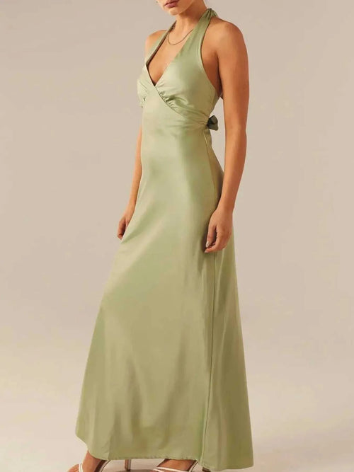 Halter neck wrap maxi dress with tie detail in light green fabric.