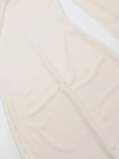 Beige asymmetrical tied sleeveless maxi dress made of 100% polyester with no stretch and machine wash care.