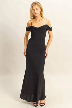 Woman wearing black HYFVE Flattering Fit Cami Maxi Dress with off-shoulder ruffled neckline and slim silhouette