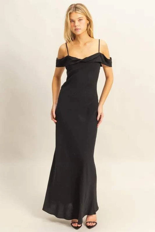 Woman wearing black HYFVE Flattering Fit Cami Maxi Dress with off-shoulder ruffled neckline and slim silhouette