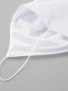 White cotton face mask with ear loops on gray background