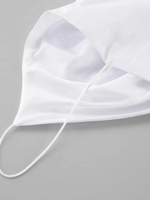 White cotton face mask with ear loops on gray background