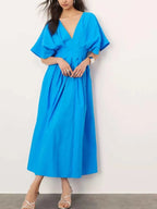 Blue V-neck half sleeve midi dress with ruched detailing and backless design made of 100% polyester.