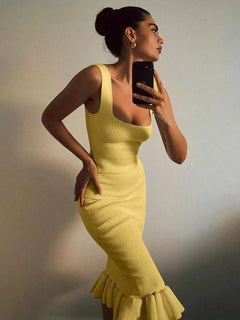 Yellow ribbed knit bodycon dress with ruffle hem worn by woman taking mirror selfie