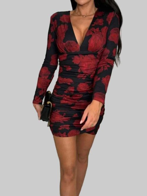 Ruched plunge long sleeve wrap dress with floral pattern.