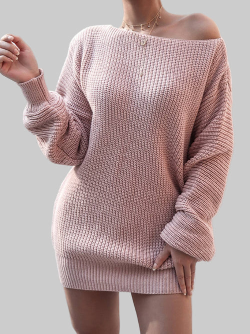 Woman wearing a blush pink rib-knit mini sweater dress with off-shoulder neckline and long sleeves in a bright indoor setting