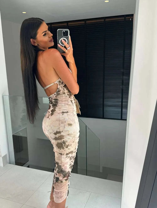 Backless printed halter neck dress in mirror selfie.