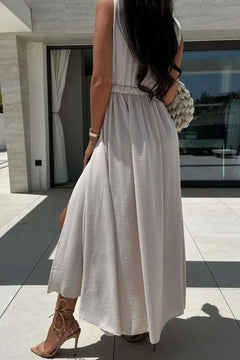 Surplice sleeveless slit maxi dress in light fabric, featuring a stylish split.