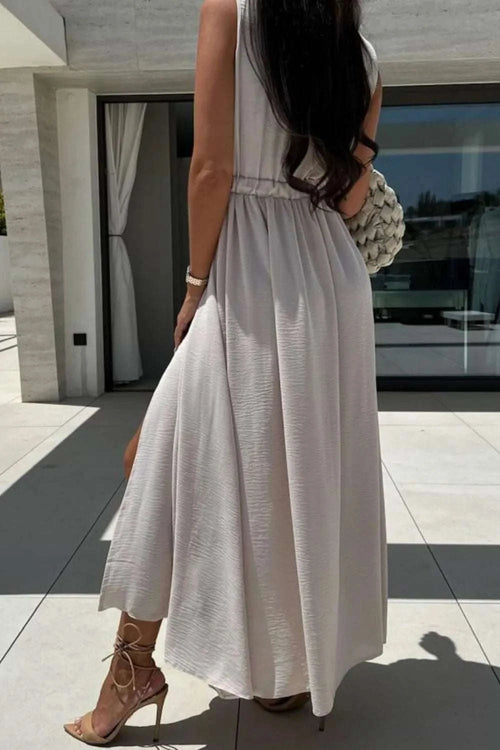 Surplice sleeveless slit maxi dress in light fabric, featuring a stylish split.