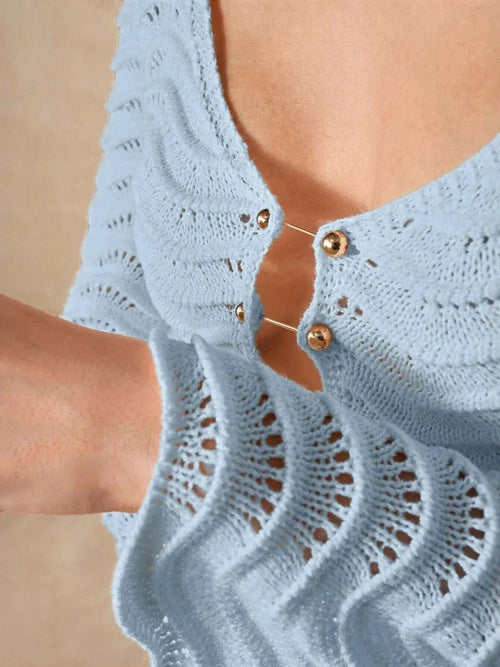 Wave openwork crochet detailing on blue maxi knit dress with cutout design.