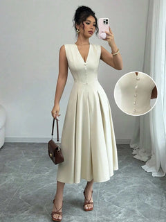 Woman wearing a white V-neck sleeveless midi dress with front button details and pleated skirt