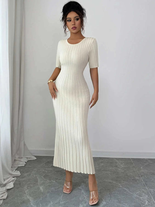 Woman wearing white ribbed round neck short sleeve sweater dress with moderate stretch reaching mid-calf