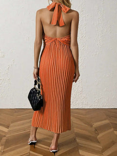 Orange pleated halter neck midi dress with tied back detail and sleeveless design
