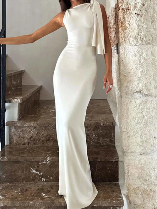 White asymmetrical tied sleeveless maxi dress made of 100% polyester with a fitted silhouette and no stretch.