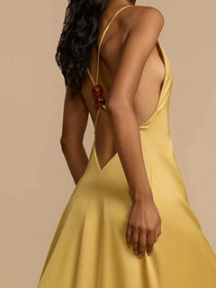 Backless deep V-neck maxi dress in yellow with crisscross straps and slightly stretchy polyester fabric