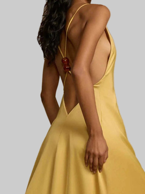 Backless deep V-neck maxi dress in yellow with crisscross straps and slightly stretchy polyester fabric