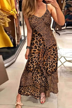 Woman wearing a Maxi Dress - Butterfly Leopard Style | Chic Cami for Bold Women with a leopard and butterfly print design in a retail store.
