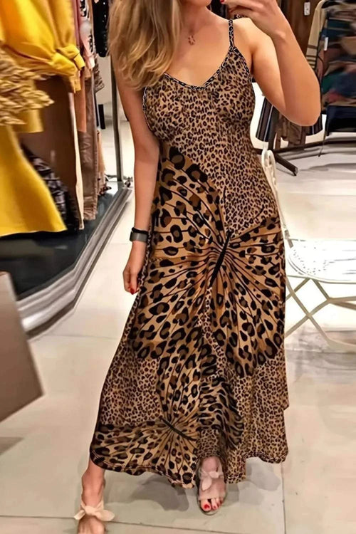 Woman wearing a Maxi Dress - Butterfly Leopard Style | Chic Cami for Bold Women with a leopard and butterfly print design in a retail store.