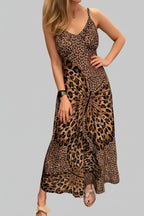 Woman wearing a Maxi Dress - Butterfly Leopard Style | Chic Cami for Bold Women with a leopard and butterfly print design in a retail store.