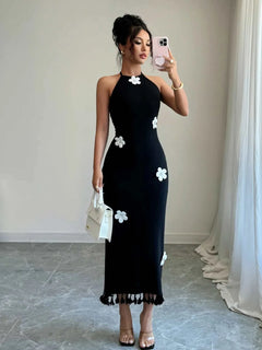 Black flower halter neck dress with white floral accents and tied neckline