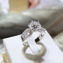 3 carat moissanite ring in 925 sterling silver with zircon accents and platinum plating displayed on white cushion