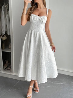 White lace-up sleeveless midi dress with ruched detailing and fitted bodice, made from 100% polyester and fully lined, shown on model in front of neutral background.