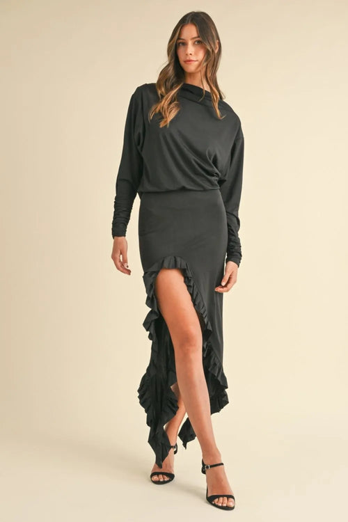 Woman wearing black Mable Backless Asymmetric Ruffle Hem Dress with high slit and ruffle detail