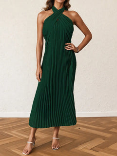 Dark green pleated halter neck midi dress with crossed neckline and sleeveless design.