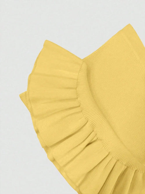 Close-up of yellow ribbed knit bodycon dress showing ruffled hem detail