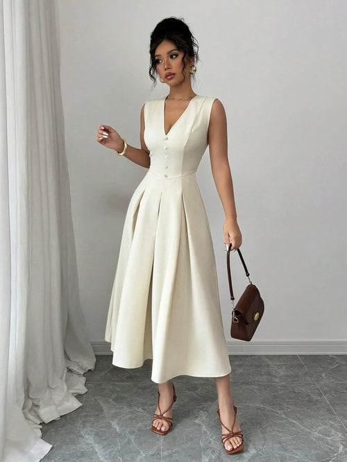 Woman wearing V-neck sleeveless midi dress in cream with buttoned front and pleated skirt holding brown handbag