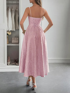 Back view of a pink lace-up sleeveless midi dress with ruched details and lined body, worn with white high-heeled sandals.